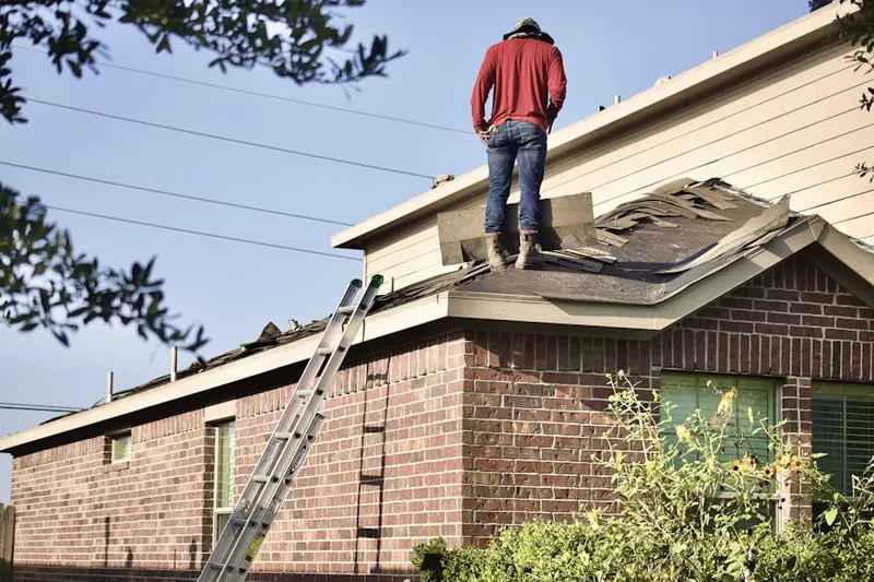 Professional roofer working on a residential roof in Sunset Knoll